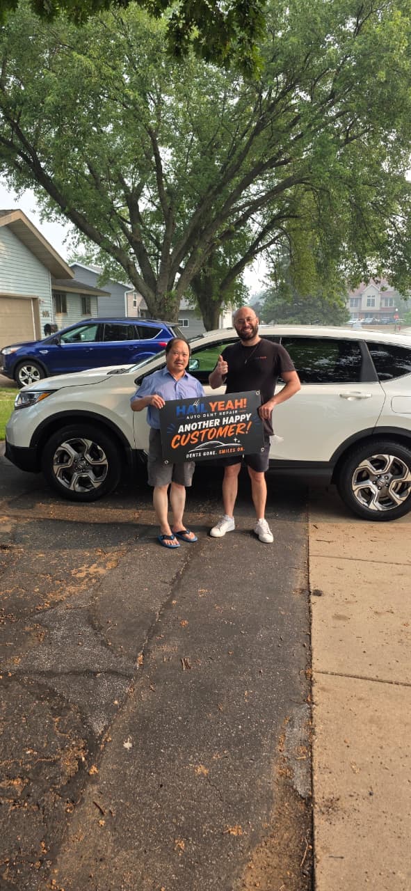 J. Reyes, Aurora, CO standing with their repaired vehicle