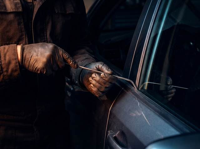 Technician accessing the panel from behind with a PDR rod tool